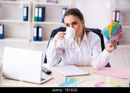 Female beautiful designer working in the office Stock Photo