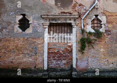 stucco and brick wall with door and windows Stock Photo