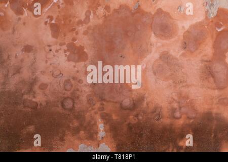 mottled orange stucco wall, textured background, room for copyspace Stock Photo