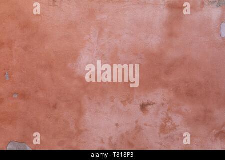Ready for repairing, peachy pink painted stucco wall, that is chipped and faded Stock Photo