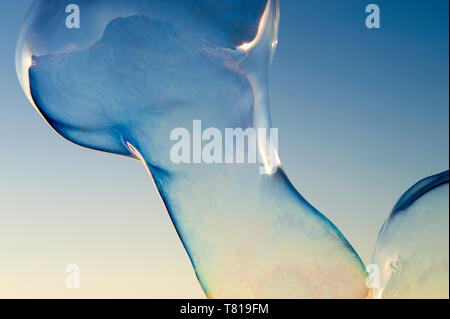 Large soap bubbles floating in blue sky Stock Photo