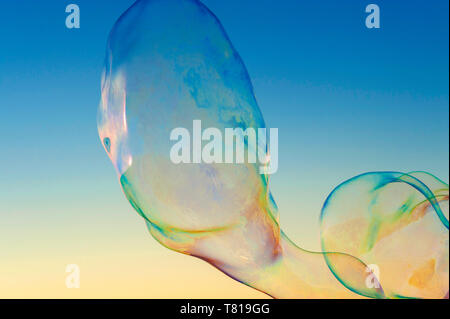Large soap bubbles floating in blue sky Stock Photo