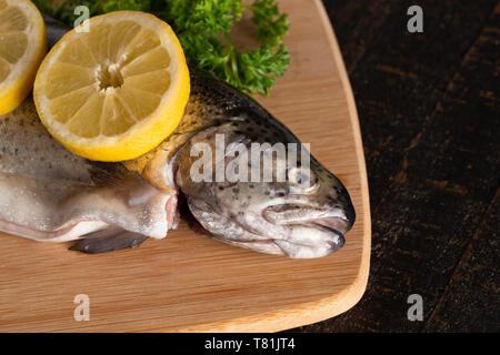 Whole Rainbow Trout on a Wooden Platter Stock Photo