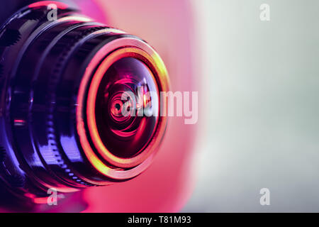 Side view of the camera with red-purple backlight. Horizontal photography Stock Photo