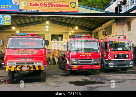 Iloilo City, Iloilo Province, Philippines - April 21, 2019: Front view of three red colored fire trucks parking at the Iloilo City Fire Station Stock Photo