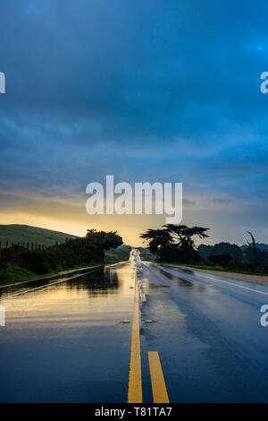 Rainy Clouds Over Wet Road Stock Photo