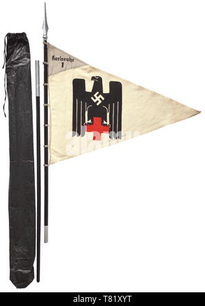 A pennant of the female detachment "Karlsruhe 1" of white flag linen printed on both sides with a polychrome German Red Cross eagle Sewn, pennant-shape light grey face with black unit inscription. 70 x 90 cm. Colour-fresh, small moth holes. Complete with seven fastening rings, two-piece black wood pole, light metal finial and storage bag. Total height ca. 250 cm. historic, historical, Deutsches Red Cross, German Red Cross, organisation, organization, organizations, organisations, relief organization, relief organizations, object, objects, stills,, Additional-Rights-Clearance-Info-Not-Available Stock Photo