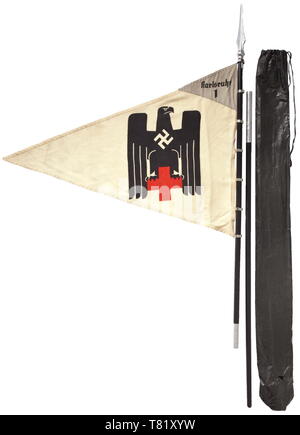 A pennant of the female detachment "Karlsruhe 1" of white flag linen printed on both sides with a polychrome German Red Cross eagle Sewn, pennant-shape light grey face with black unit inscription. 70 x 90 cm. Colour-fresh, small moth holes. Complete with seven fastening rings, two-piece black wood pole, light metal finial and storage bag. Total height ca. 250 cm. historic, historical, Deutsches Red Cross, German Red Cross, organisation, organization, organizations, organisations, relief organization, relief organizations, object, objects, stills,, Additional-Rights-Clearance-Info-Not-Available Stock Photo