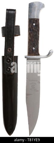 A Hitler Youth knife with etching commemorating the 1936 Olympics. Maker Emil Voss, Solingen. The etched blade with Berlin bear, Olympic Rings, national eagle, and 'Zum Ruhme Des Sports Zur Ehre Des Vaterlandes' (For the glory of sport for the honour of the Fatherland) in colour and gilding. Reverse etched with manufacturer's trademark. Polished aluminium hilt with wooden grip plates simulating stag with enamelled HJ emblem. Black lacquered steel scabbard with black riveted hanger. Complete with brown paper factory issue bag. Length 21 cm. USA-lot historic, historical, 20th, Editorial-Use-Only Stock Photo