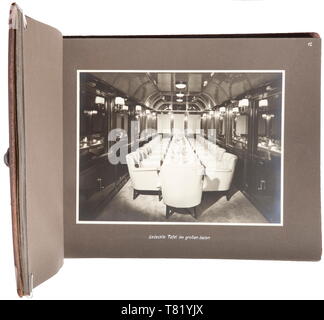 A photo album of Adolf Hitler's lounge- and sightseeing carriage. Inscribed, large-format album with brown leather cover, within which are 54 images in 9 x 14 cm to 17 x 23 cm sizes detailing the lounge carriage of Reich Chancellor A. Hitler (the so-called 'Führeraussichtswagen'). The photos are indoor shots, of the guest book and (for the period) of the modern vehicle engineering (complete glazing). Album dimensions 33 x 25 cm. The carriage (factory designation Bln 10 282) was built by the Fuchs firm in Heidelberg and is in private possession today. historic, historical, 2, Editorial-Use-Only Stock Photo