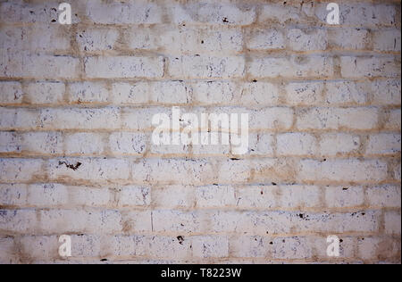 Abstract solid background depicting an old white wall, painted, worn and scratched by time. Stock Photo