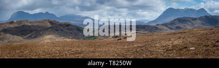 Looking over the hills of Assynt from Aird na Coigach with the peaks of Suilven, Canisp and Cul Mor closest to camera. A rain shower is approaching an Stock Photo