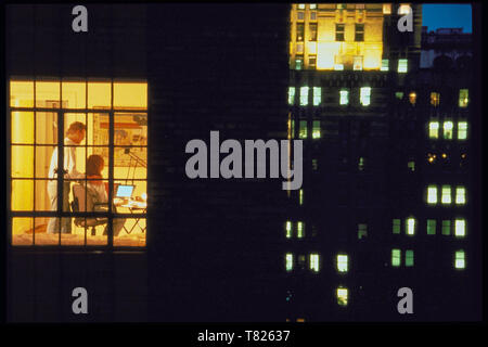Couple Working late in high-rise apartment Home Office, NYC, USA Stock Photo