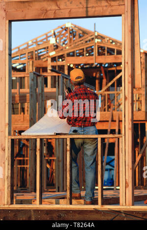 Contractor on site at House under construction, USA Stock Photo
