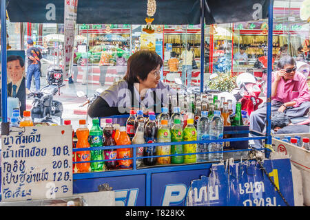 Bangkok, Thailand - April 21st 2011: Woman behind her mobile drinks stall in Chinatown. People often buy drinks as it is so hot. Stock Photo