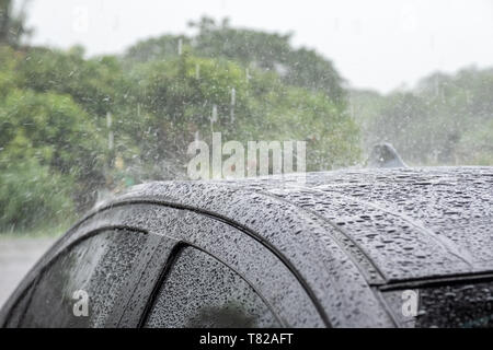Raindrop falling on gray roof car Stock Photo