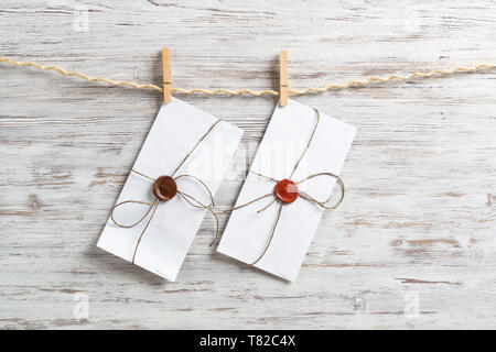White envelopes hanging on rope Stock Photo