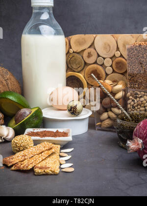 Food ingredients containing zinc, sesame, nuts, coconut, dairy products, black caviar, meat, cocoa.The concept of a healthy diet Stock Photo