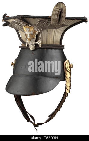 A czapka M 1843 for officers of the Garde-Landwehr Uhlans 1. Esc. Leather skull with stitched-down white cover, leather top, front peak and sewn-on rear peak, extremely darkened silver round cord trimming. Convex chinscales (somewhat damaged, but complete) on screws. Nickel silver heraldic eagle with golden Landwehr star.Eagle composed of various parts. Sheep leather lining. Field insignia missing. historic, historical, Prussian, Prussia, German, Germany, militaria, military, object, objects, stills, clipping, clippings, cut out, cut-out, cut-out, Additional-Rights-Clearance-Info-Not-Available Stock Photo