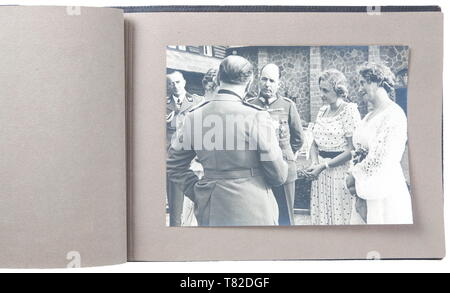Hermann Göring - A photo album of Mussolini's official visit to Carinhall Large format photo album (34 x 24 cm) with brown leather cover with gold-embossed 'MUSSOLINI BEI GOERING IN KARINHALL', '28 SEPTEMBER 1937' and 'BILDBERICHT VON CARLO CARLETTI'. Album consists of eighteen 17 x 23 cm black and white photos. Photos are of a casual/informal style and feature Hermann Göring, Emma Göring, Mussolini, Count Ciano, Achille Starace, Luftwaffe Generals Milch, Stumpf, and Bodenschatz, Paul Schmidt, SS General Dietrich, and more. From the possession of a US officer of the 101st A, Editorial-Use-Only Stock Photo