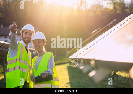 Electrical engineers are checking and repairing. fitting a photovoltaic plant in solar power station alternative energy from nature, Clean Energy,Rene Stock Photo