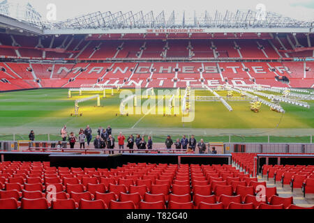 Old Trafford, Manchester, UK - January 20, 2019: Manchester United football stadium, looking at the Alex Ferguson Stand and shows a group of fans havi