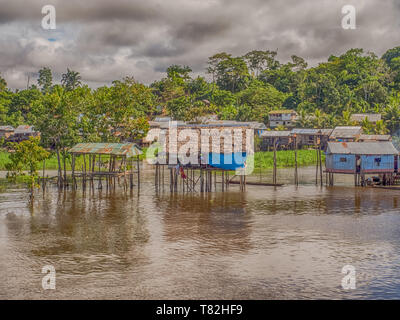 Amazon River, Peru - May 13, 2016:  Small village on the bank of the Amazon River Stock Photo