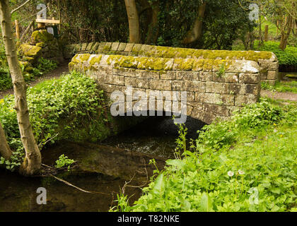 Small footbridge over stream in Beeley Village Derbyshire, Peak District UK