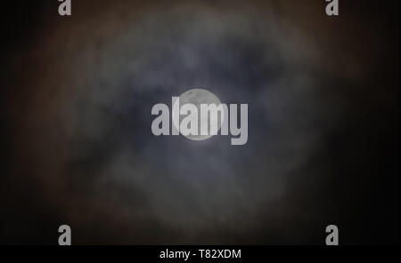 Full moon, with clouds passing over Stock Photo