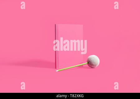 Pink notebook, diary, journal on a pink background with a green pencil Stock Photo