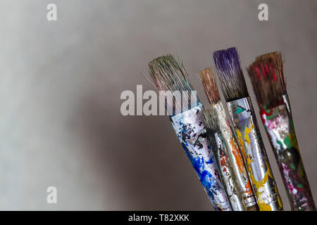 Paint brushes with visible paint marks on plain background Stock Photo