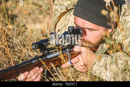 Bearded man hunter. Military uniform fashion. Army forces. Camouflage. Hunting skills and weapon equipment. How turn hunting into hobby. Man hunter with rifle gun. Boot camp. Say good bye Stock Photo