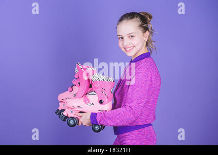 Lets ride. Girl cute little child hold roller skates. Hobby and active leisure. Happy childhood. Pick proper roller skates size. Why kids love roller skates. Roller skates every girl dreaming about. Stock Photo