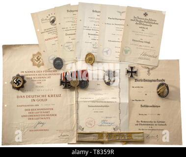 The estate of Paratrooper Franz Denzinger German Cross in Gold, 'heavy' issue of maker Deschler, Munich. The attachment pin (old repair between hinge and pin) with '1' punch. Weight 70.5 g. Included is the award document dated '5. FEBRUAR 1944' (holed, creased, the reverse laminated). Also, a Paratrooper's Badge with the award document dated '26. September 1940', a Luftwaffe Ground Combat Badge, silver-plated fine zinc with riveted eagle and the award document dated '26.Mai 1943' with original signature of Student, and a 'Kreta' cuff title, examplar detached from a uniform,, Editorial-Use-Only Stock Photo