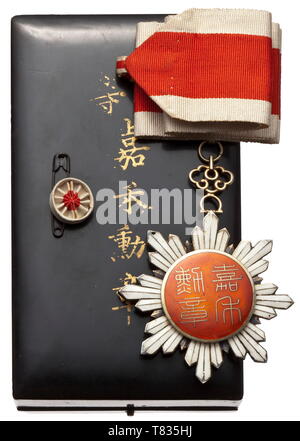 An Order of the Golden Grain Eight-pointed star, 3rd class, gilt silver, polychrome enamelled, on originally customised neck ribbon. The order and the miniature ribbon rosette is stored in a black lacquer case with the order and class specification in gold characters. The award was established when the Republic of China was founded in 1912 and only existed until 1929 when it was abolished and replaced by the Order of Brilliant Jade by President Chiang Kai-shek. Width 61.5 mm. Weight 59.4 g. historic, historical, 20th century, Additional-Rights-Clearance-Info-Not-Available Stock Photo