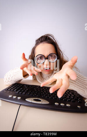 Funny nerd girl working on computer Stock Photo
