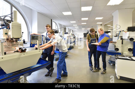 Group of young people in technical vocational training with teacher Stock Photo