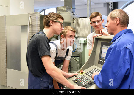 Group of young people in technical vocational training with teacher Stock Photo