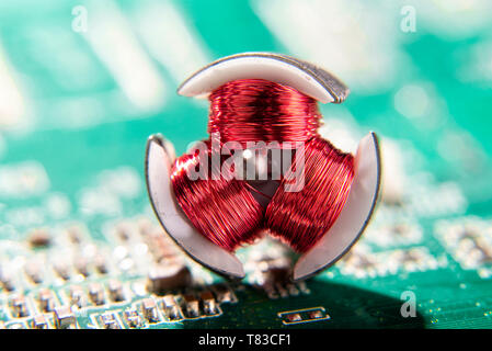 Red coils of an electric motor with circuit board Stock Photo
