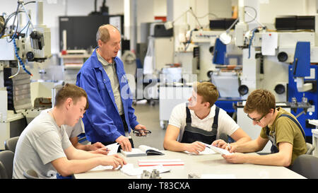 Group of young people in technical vocational training with teacher Stock Photo