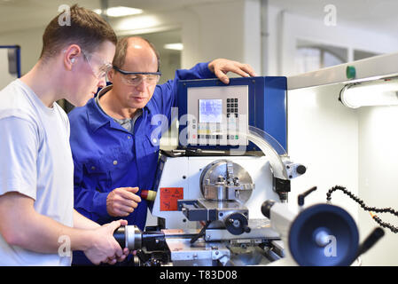 Group of young people in technical vocational training with teacher Stock Photo