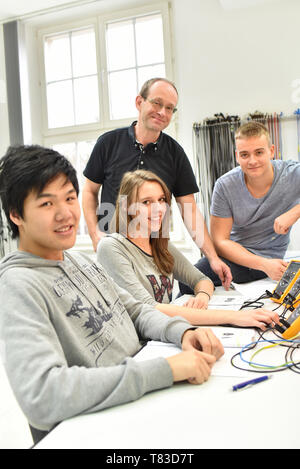 technical vocational training in industry: young apprentices and trainers in the classroom Stock Photo