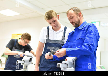 Group of young people in technical vocational training with teacher Stock Photo