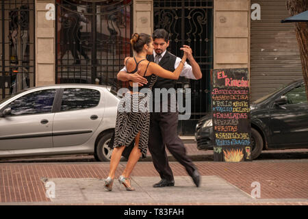 It is common to find tango dancers in the Plaza Dorrego of the historic center of San Telmo, Buenos Aires, Argentina, who offer their art to tourists. Stock Photo