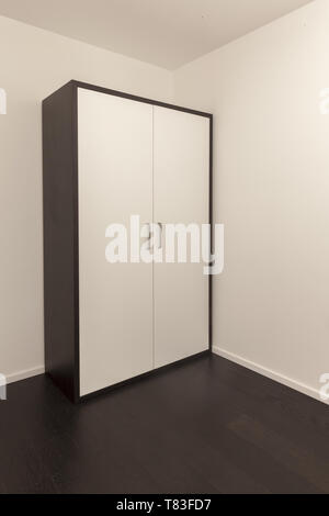 fashionable brown and white wardrobe in an empty room Stock Photo