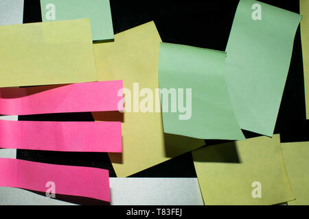 Blank different colored sticky notes taped on a blank laptap screen Stock Photo