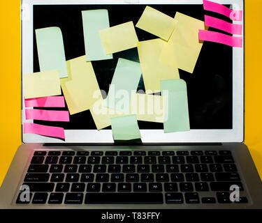 Colourful sticky notes on a blank screen of a laptap Stock Photo