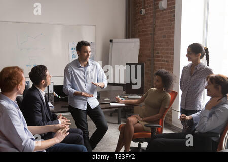 Diverse employees brainstorm sharing ideas at office meeting Stock Photo