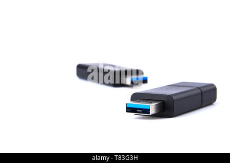 Detailed view of two black USB flash drive with silver blue connector. Photo on white background with space for your text. Stock Photo