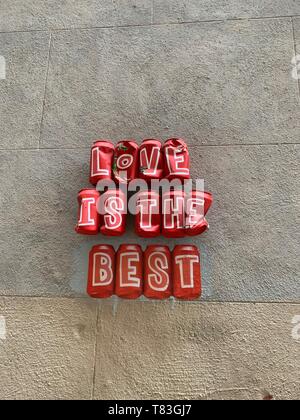 Uplifting Street Art Installation made out of recycled Coca Cola cans with a message of love Stock Photo